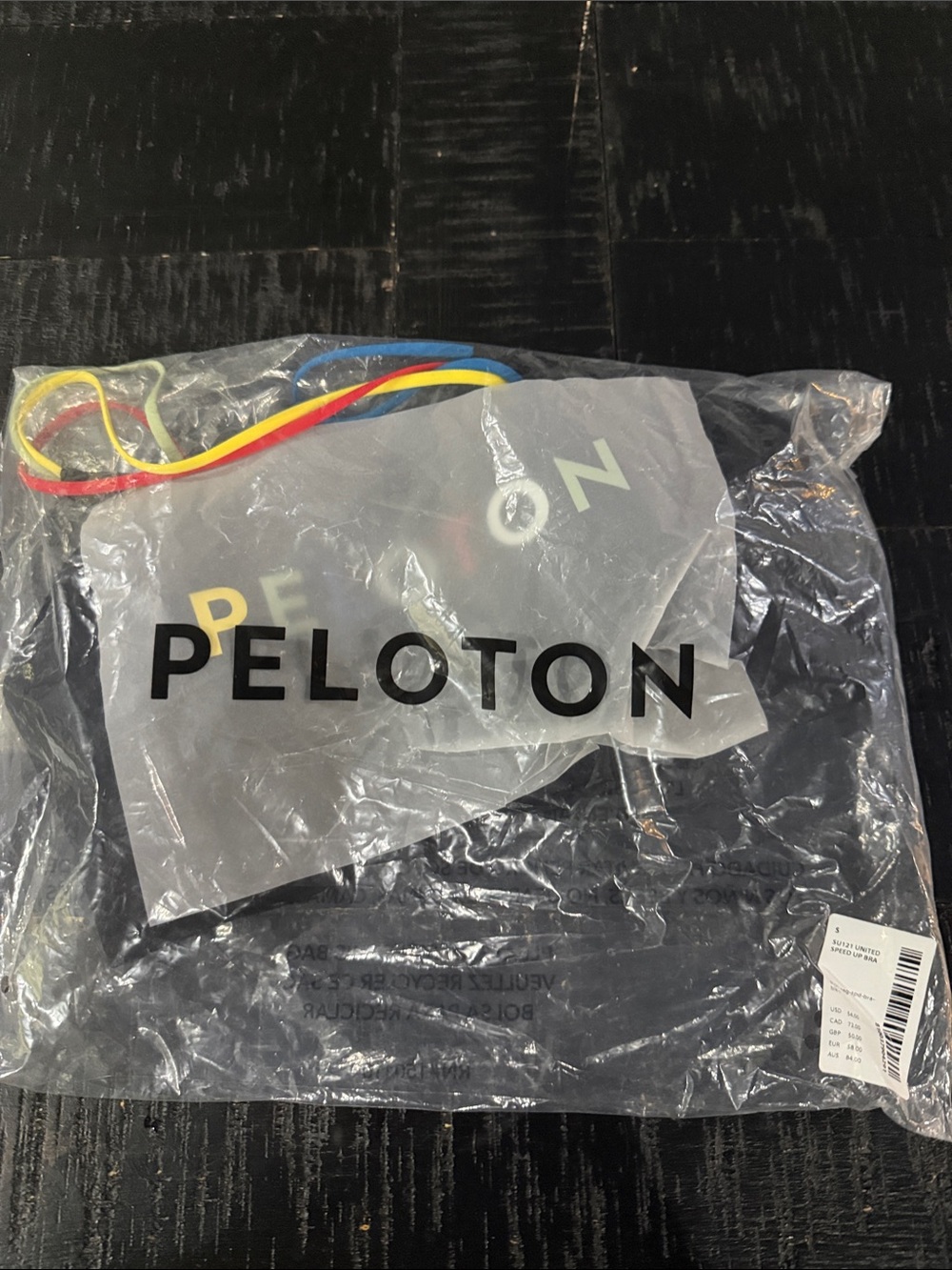 Peloton Black Sports Bra with Red, Yellow, and Blue Bands